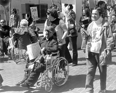 A photo of protesters marching demanding civil rights recognition and Section 504 enforcement under the Rehabilitation Act of 1973.