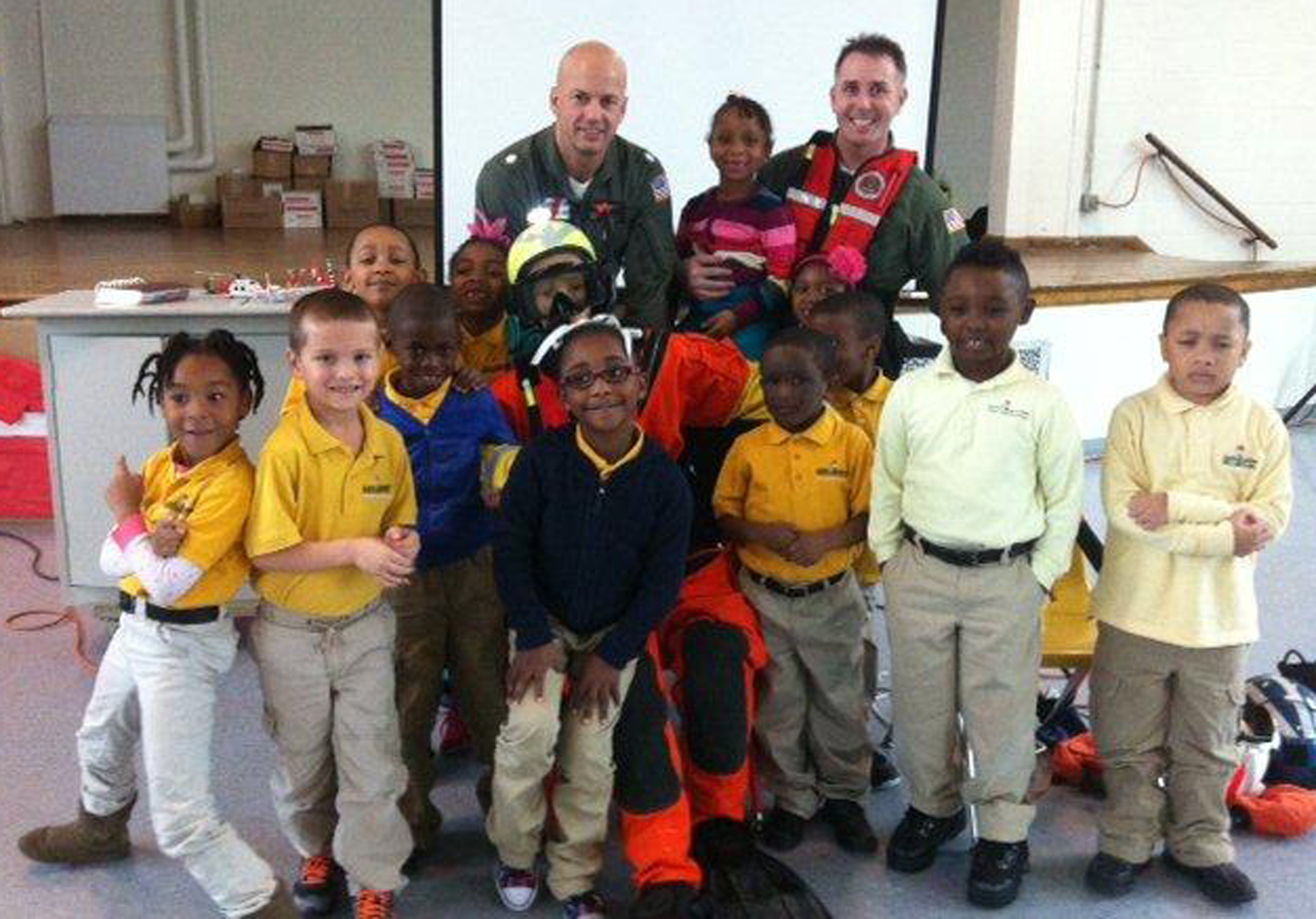 Coast Guard personnel, students, and educators posing at various Partnership In Education locations